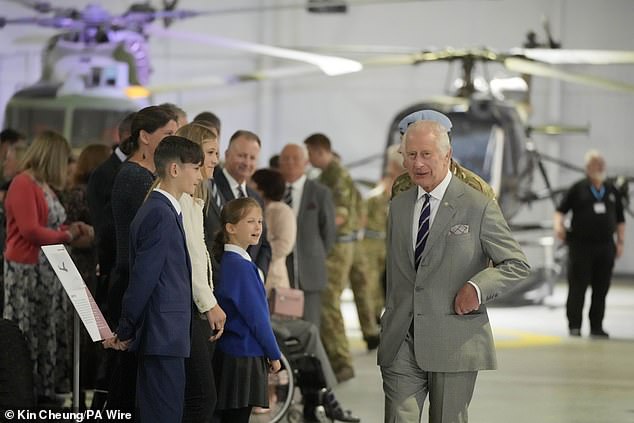 King Charles III meets staff members and their families at the Army Aviation Centre today