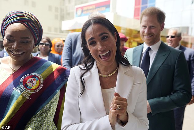 Harry and Meghan speak to military wives at the Defence Headquarters in Abuja on Friday