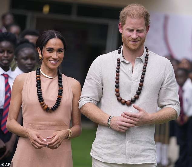 Meghan added a bit more glamour by wearing Diana's gold Cartier Tank Française watch