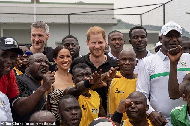 The team of injured veterans gathers for a happy photograph with the visiting couple