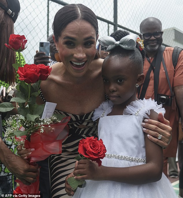 Meghan Markle delighted locals as she posed for a slew of snaps during her visit to Nigeria with Prince Harry