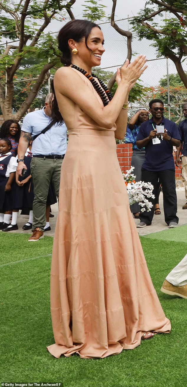 Meghan Markle wears a long ruffled dress as she visits Lightway Academy last week in Abuja, Nigeria