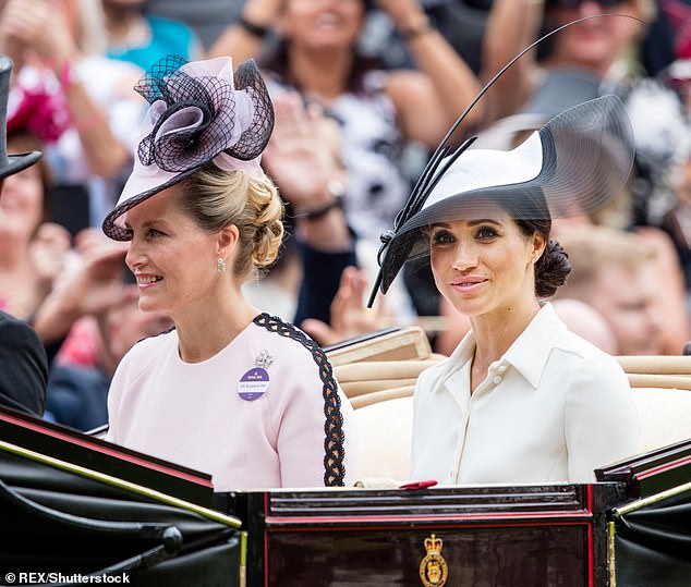 Sophie is pictured sitting alongside Meghan in a carriage for Royal Ascot in 2018