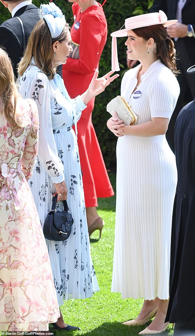 Princess Eugenie was also seen deep in conversation with Carole Middleton before the races got underway (pictured)