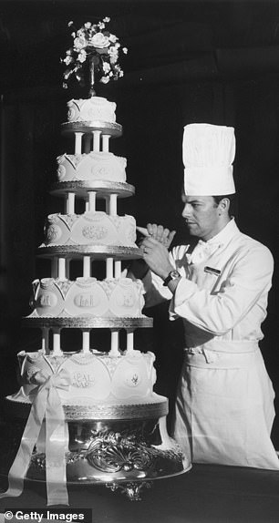 Sergeant Major David Dodd of the Army Catering Corps applies the finishing touches to the wedding cake for Princess Anne and Captain Mark Phillips