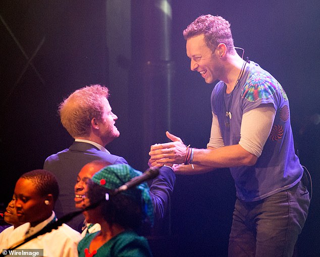 Prince Harry (left) were pictured on stage in 2014 after Coldplay were commissioned (Chris right) to write a song for the inaugural of the Invictus Games