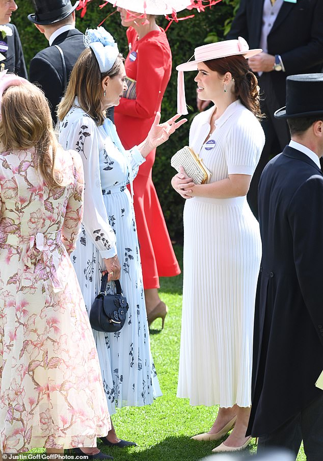 Princess Eugenie was also seen deep in conversation with Carole Middleton before the races got underway (pictured)