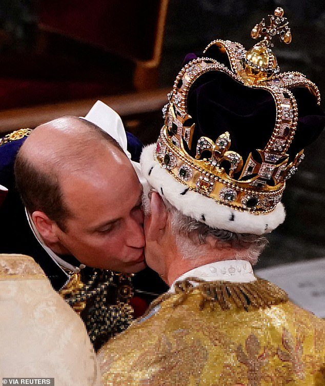 Prince William kisses his father King Charles on the cheek during the monarch's coronation ceremony in 2023