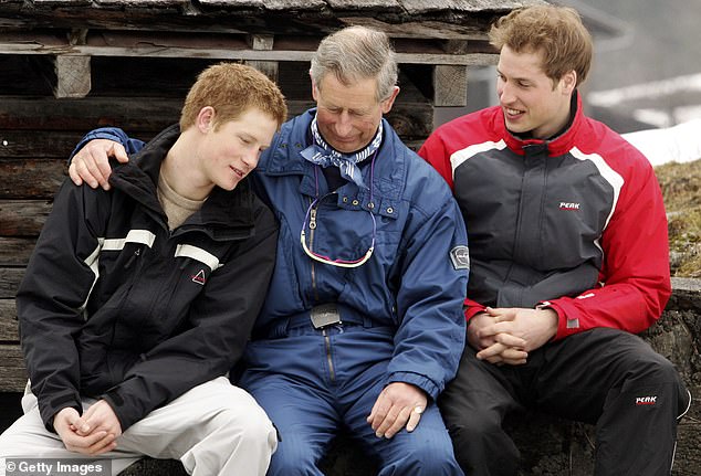 The then-Prince Charles poses for photographs with Prince Harry and Prince William during the Royal Family's ski break in Klosters in 2005