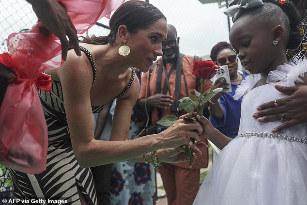 The Duchess of Sussex, 42, watched on from the sidelines in Johanna Ortiz's Tropicana Nights dress, which features a black and cream palm leaf style design, with cut out detailing under the bust