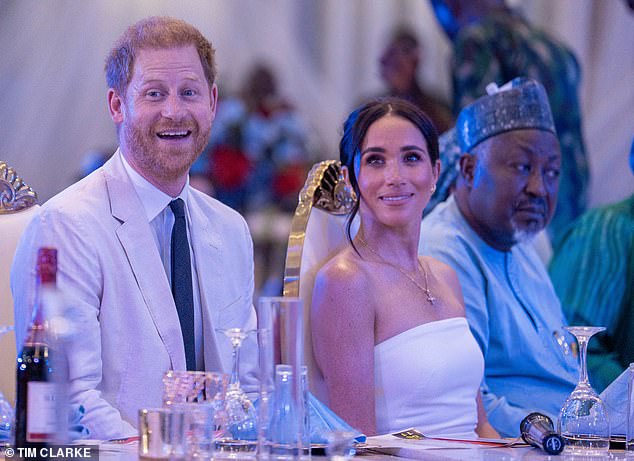 The couple looked engaged as entertainment was supplied to those in attendance