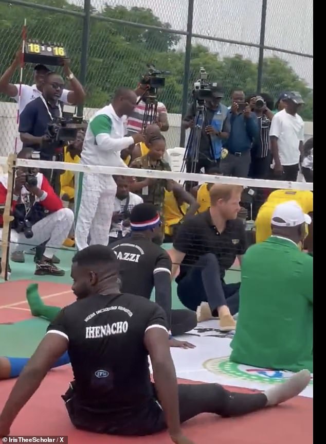 Prince Harry is seen taking part in one of the seated volleyball matches with other players