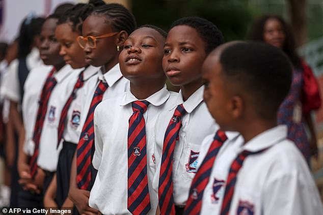 Children excitedly watched the visit by Harry and Meghan to the Wuse Lightway Academy in Abuja today