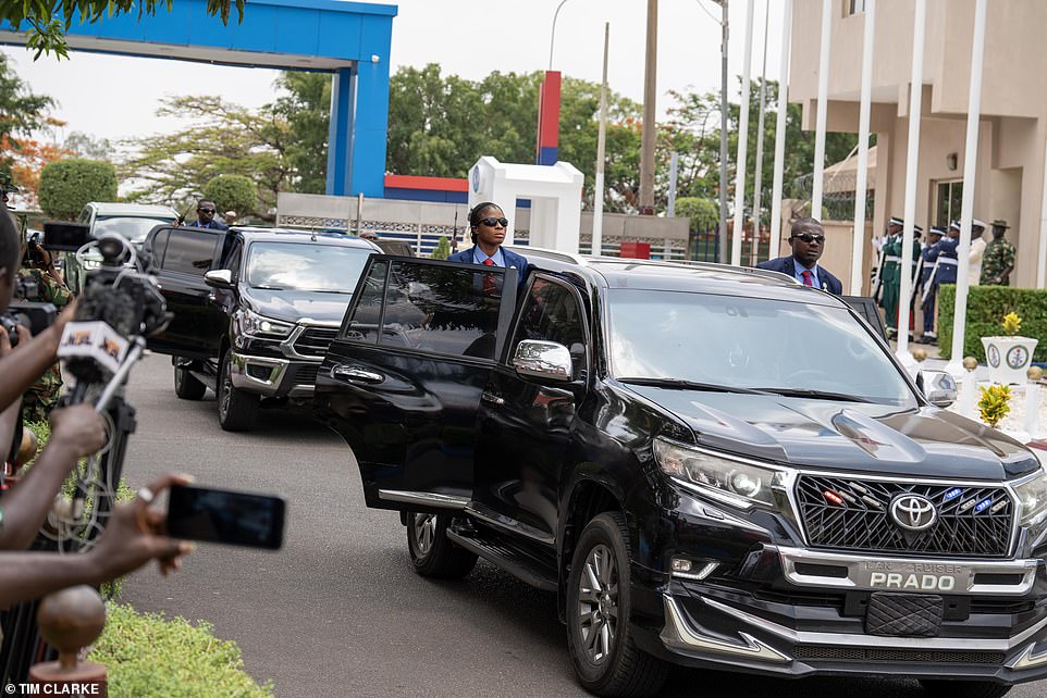 An uncomfortable looking Harry quickly ushered Meghan into their car as onlookers almost overwhelmed them. The couple arrived together in Abuja just before 5am following a secret reunion at Heathrow's VIP Windsor Suite yesterday after the Duchess arrived from Los Angeles. They boarded the British Airways overnight flight to Abuja, which was slightly delayed after the scheduled pilot went sick and a replacement had to be scrambled.