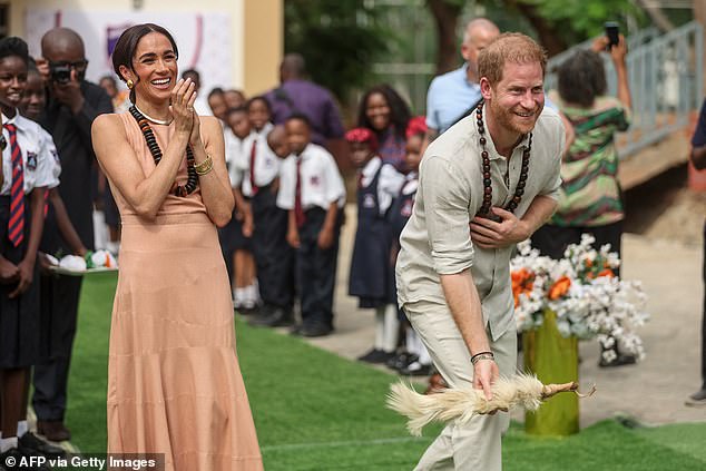 Harry and Meghan take part in games at the Wuse Lightway Academy in Abuja today