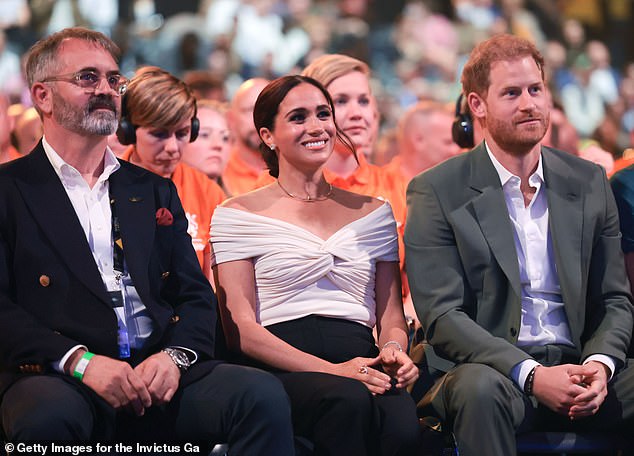 Invictus Games Foundation CEO Dominic Reid, (left) Harry, and Meghan, Duchess of Sussex (centre) at the Invictus Games The Hague 2020 Opening Ceremony