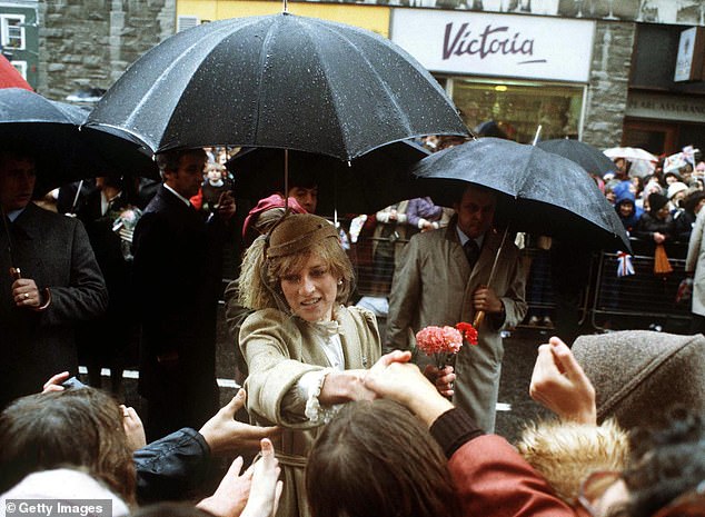 The late Princess Diana found herself caught in a downpour during a walkabout in Carmarthen, Wales, in October 1981