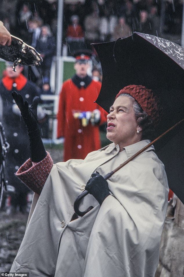 Known for her passion for horses, little would stop the late Queen from presenting a silver plate to a winner at the Royal Windsor Horse Show in 1975. The Queen was pictured taking shelter under an umbrella as rain bounced off the ground