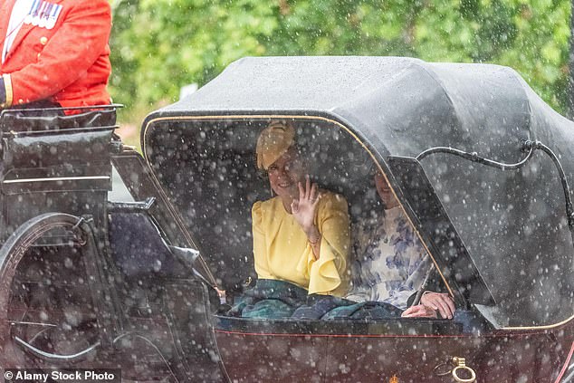 The parade continued through the rain, Sophie waved to crowds from under the hood of the carriage