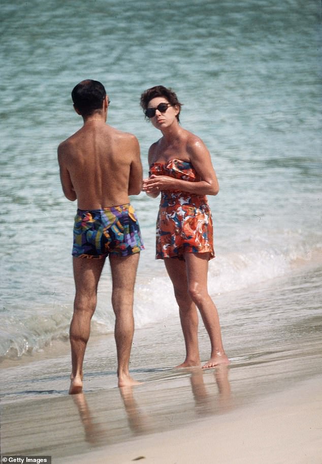 Princess Margaret pictured talking to a friend on the sandy shores of the luxurious island