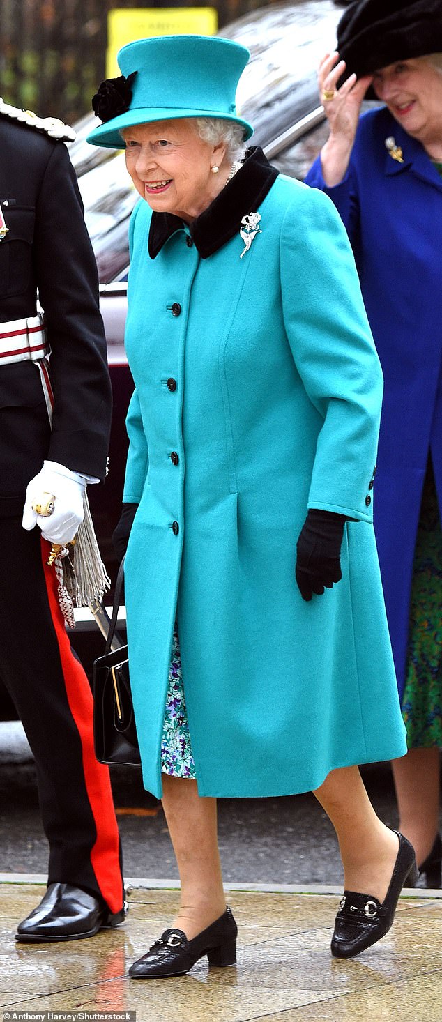 2018: The late Queen Elizabeth places 27th on Tatler's list. Above: She wears a bright sky blue coat and matching floral dress for a visit to children's charity Coram in London