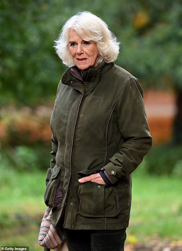 Queen Camilla places a hand in her Musto jacket while visiting Westonbirt, The National Arboretum, Tetbury, in 2020