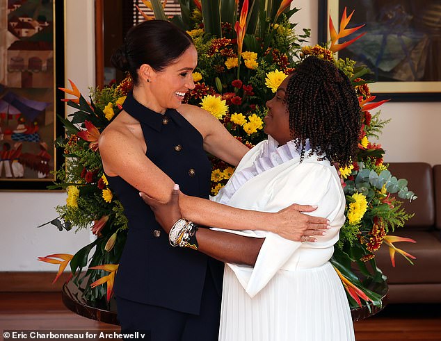 Cinched at the waist to flatter the Duchess' slender figure, the smart ensemble was paired with black Manolo Blahnik high heels and a cream $4,700 handbag from Italian company Loro Piana