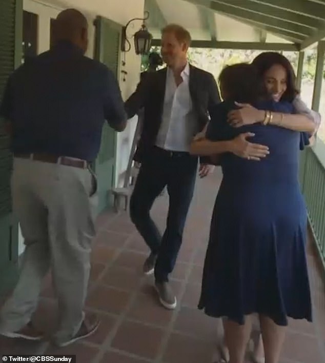 Harry and Meghan were shown embracing parents from The Parents' Network as they met in person for its launch