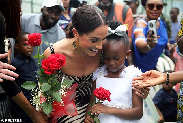 The mother-of-two embraced members of the public during her quasi-royal tour of Nigeria with Prince Harry in May