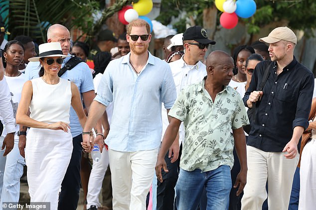 Meghan and Harry walk through the streets of San Basilio de Palenque in Columbia