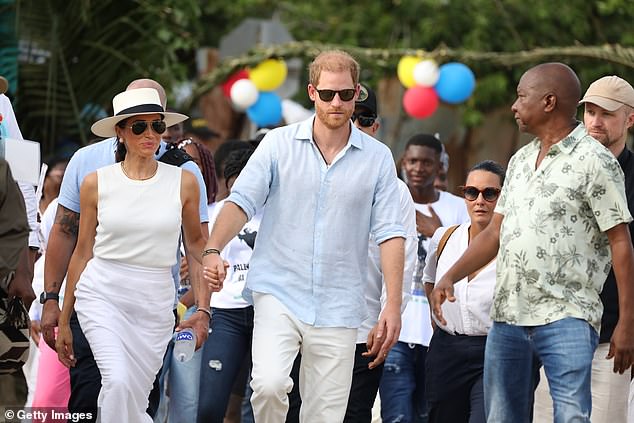 The pair were surrounded by people as they walked through the streets of San Basilio de Palenque