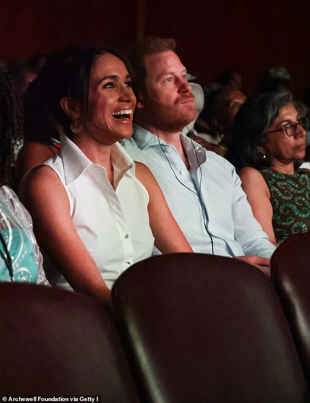 Meghan and Harry laugh as they sit in the audience at the Afro Women and Power event