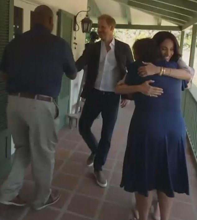 Harry and Meghan were shown embracing parents from The Parents' Network as they met in person for its launch