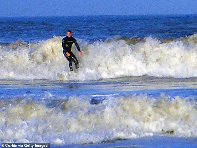 Prince William learnt to surf while at St Andrews in Scotland. The prince is pictured catching a wave in October 2004