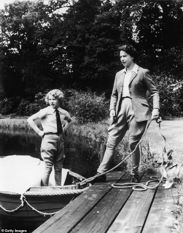 A young Princess Anne stands on a boat while the Queen is nearby at Frogmore in Windsor in 1959