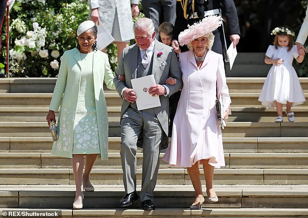 Doria linking arms with King Charles at her daughter's wedding in May 2018