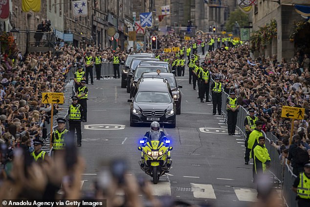 Crowds gather to see the Queen's coffin proceed down the Royal Mile in Edinburgh on September 11, 2022