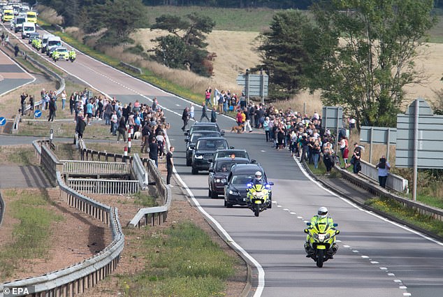 The hearse carrying Elizabeth's coffin travels to Edinburgh as people stand by on the side of the road to pay their respects