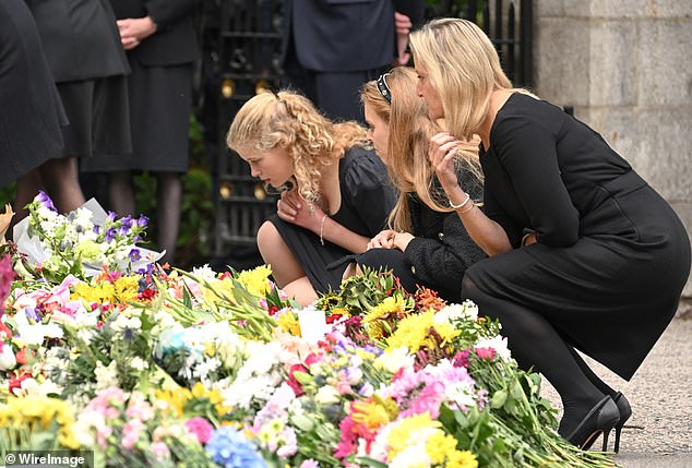 The Queen's granddaughters, Lady Louise Windsor and Princess Beatrice, as well as Sophie, the then Countess of Wessex, look at tributes left outside of Balmoral Castle, September 10, 2022