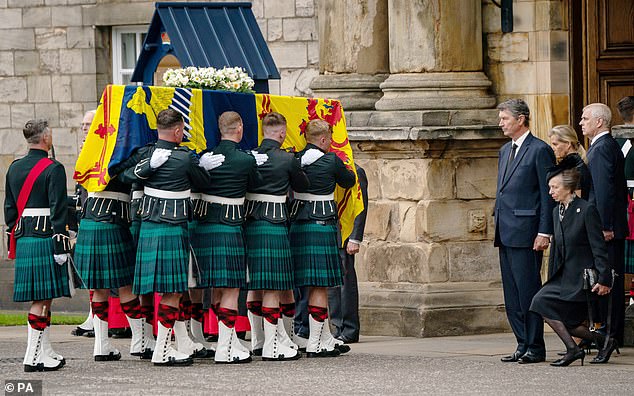 The Queen's coffin being carried into the Palace of Holyroodhouse in Edinburgh on September 11. Princess Anne curtsies while Timothy Laurence, Sophie, then the Countess of Wessex, and Prince Andrew watch on