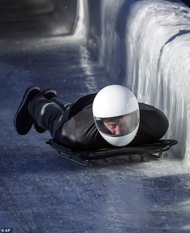 The Duke of Sussex is pictured sliding down the track on a skeleton sled during an Invictus Games training camp Prince Harry, the Duke of Sussex, slides down the track on a skeleton sled during an Invictus Games training camp in February