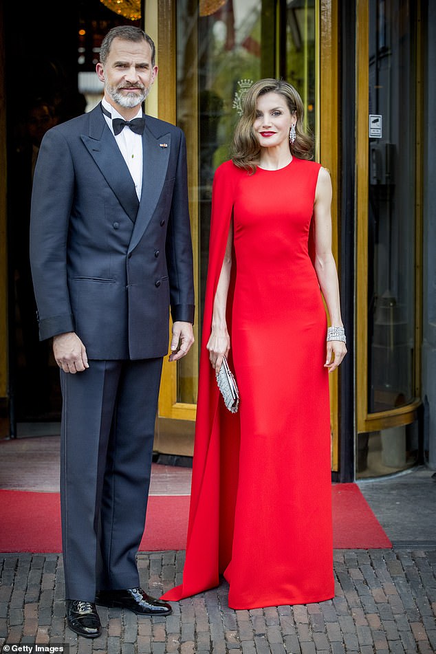 Queen Letizia of Spain demonstrated the power of a red dress in a statement frock from Stella McCartney, incorporating a figure-skimming cut and one-shoulder cape