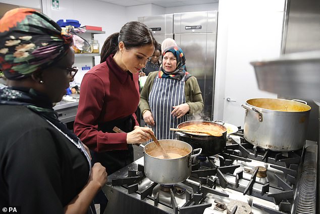 Meghan helps prepare food during her visit to the Hubb Community Kitchen in 2018