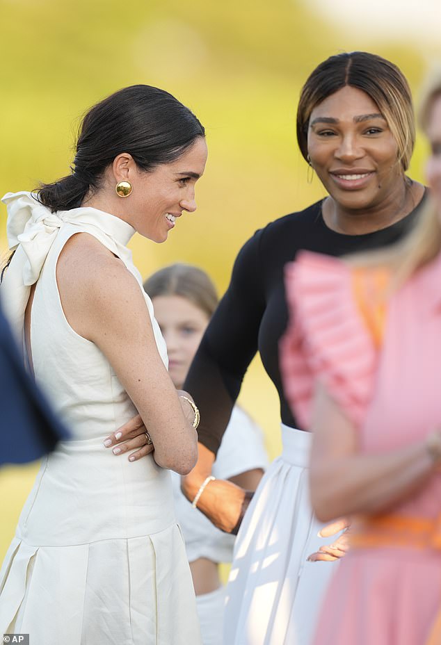 Meghan Markle is pictured speaking with her friend Serena Williams at the Royal Salute Polo Challenge in April