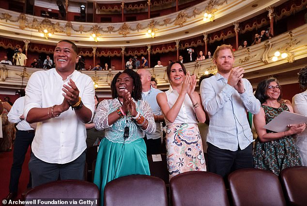 Yerney Pinillo, Ms Marquez, Meghan, and Harry stand and applaud during the Afro-Descendant Women and Power conference