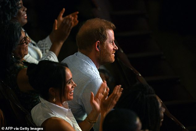 Harry sits in the audience with an earpiece which translates the Spanish into English