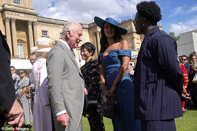 King Charles III speaks with Maya Jama and Campbell Addy at The Sovereign's Creative Industries Garden Party at Buckingham Palace, on May 15