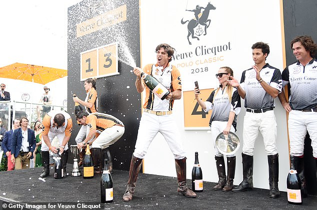 Polo player Nacho Figueras sprays champagne onstage after the 11th annual Veuve Clicquot Polo Classic at Liberty State Park - will he bring the booze to the party?