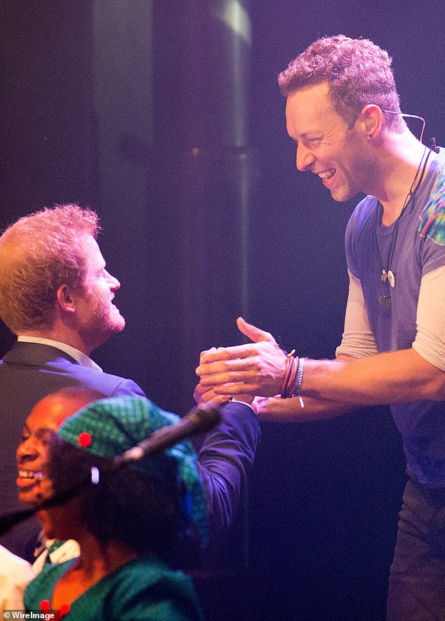 Prince Harry (left) were pictured on stage in 2014 after Coldplay were commissioned (Chris right) to write a song for the inaugural of the Invictus Games