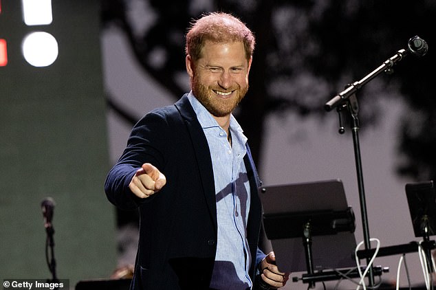 The Duke of Sussex opted for a navy blue suit jacket with a light blue shirt as he stepped on stage